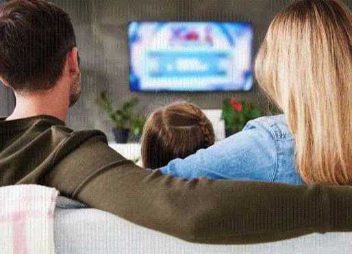 Couple and child at TV squeesed vertical